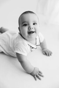 black and white photo of baby smiling