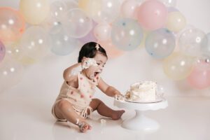 baby girl excitedly smashing her cake raleigh nc