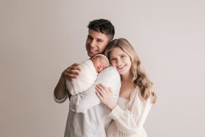 mom and dad posing with newborn baby, raleigh newborn photographer