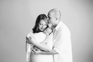 parents embracing newborn raleigh