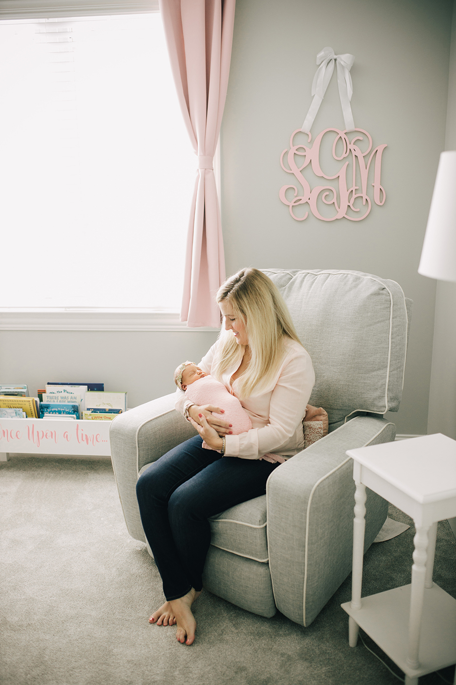 mom with newborn in nursery raleigh lifestyle photographer