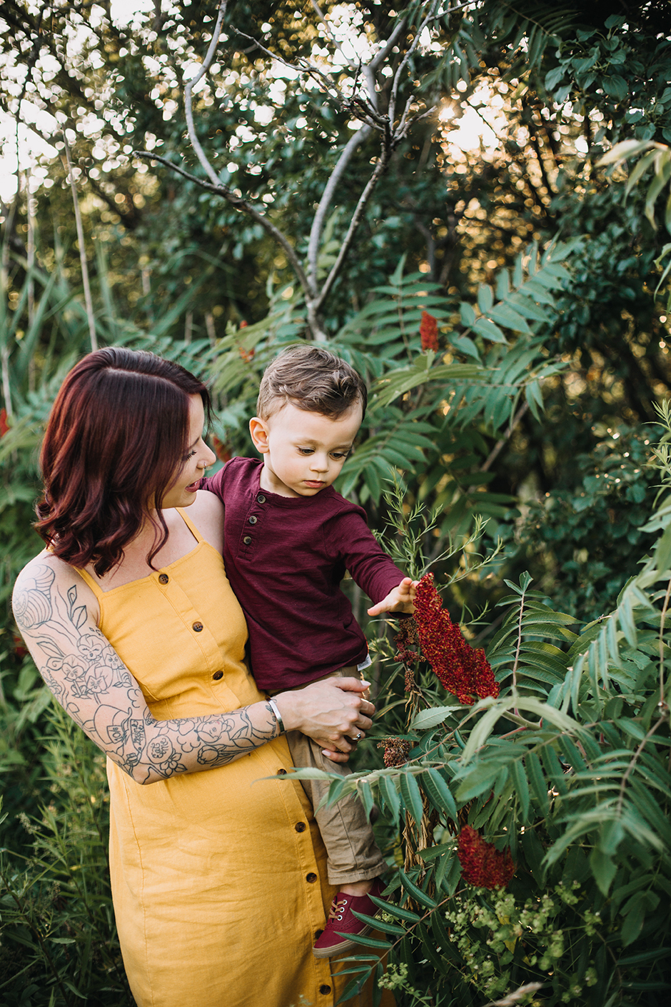 mom and son looking at flowers