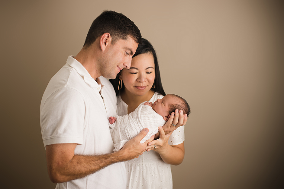 parents gazing at newborn