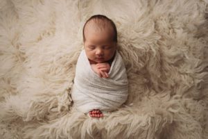 Swaddled newborn photo
