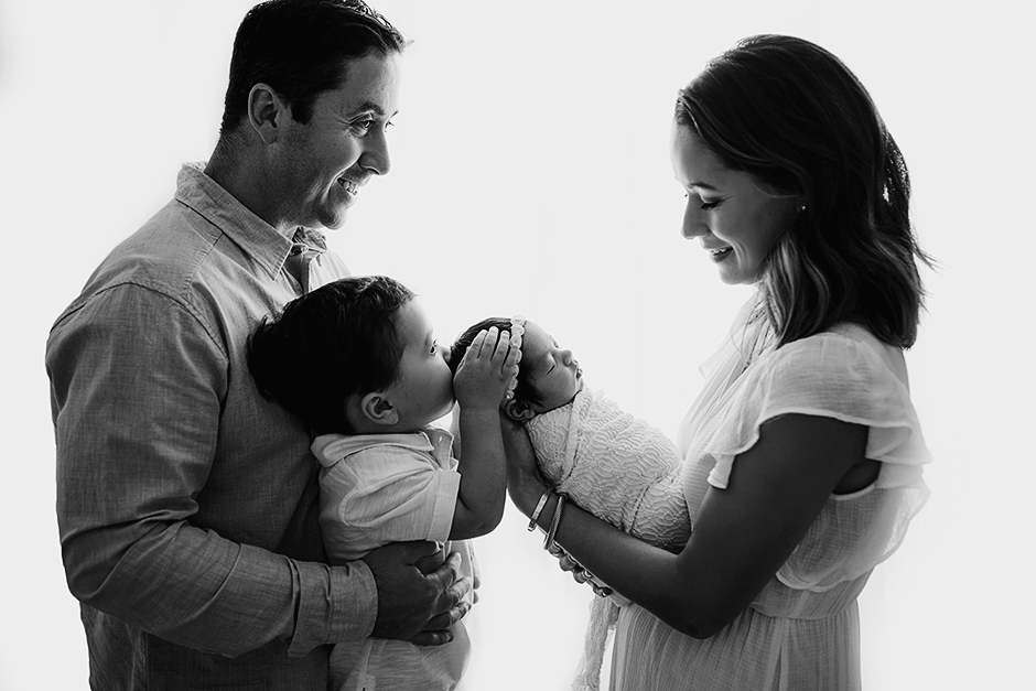 Beautiful backlit newborn family photo in Cary studio