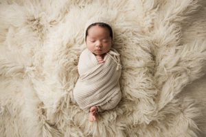 swaddled baby in bonnet in Cary NC