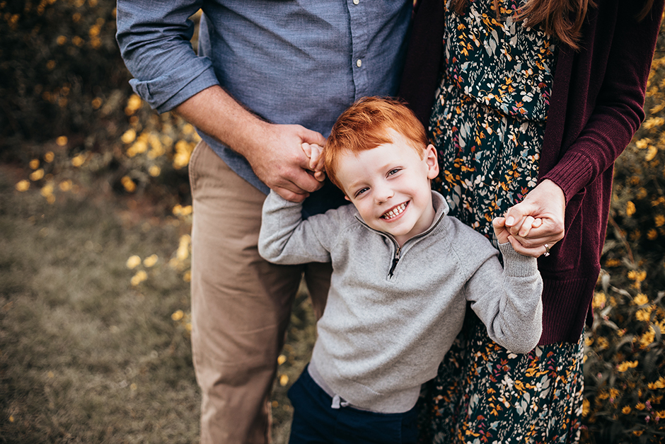 5 year old holding parents hands raleigh family photographer