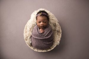 newborn swaddled in purple, newborn photographer raleigh