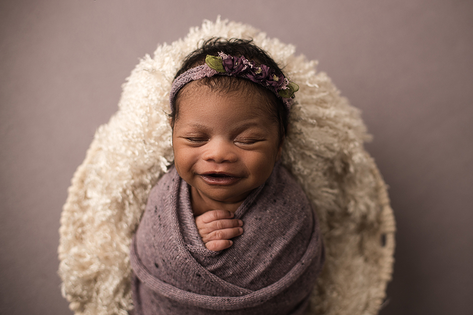 baby smiling in purple swaddle, mini newborn session cary