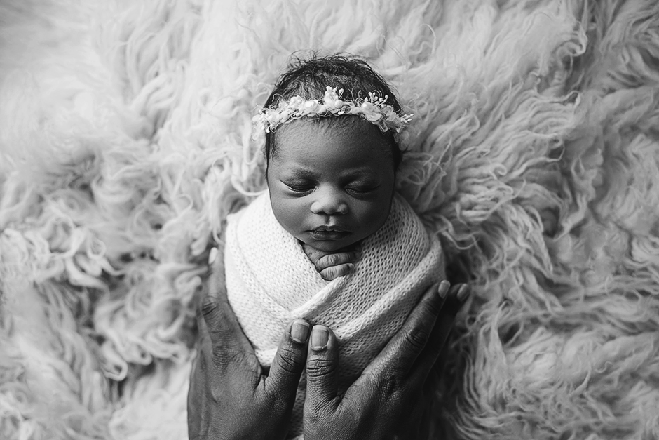 newborn swaddled with mom's hands, newborn photographer in apex