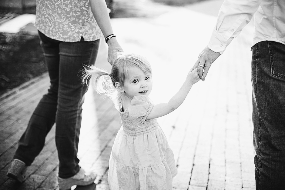girl holding parents hands family photos raleigh