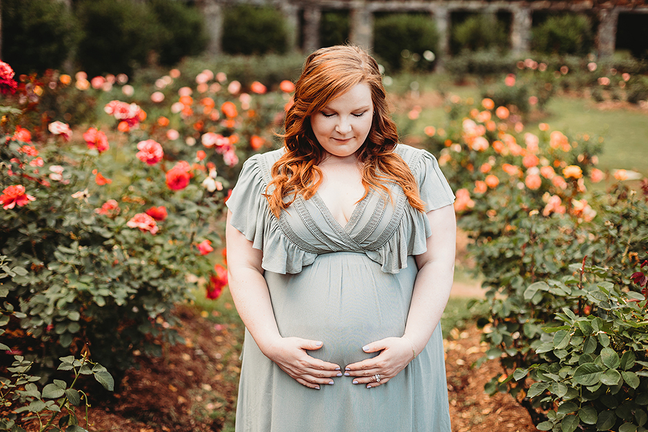 Pregnant woman in raleigh rose garden