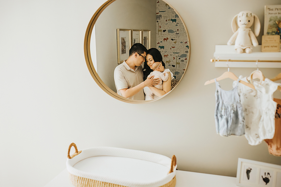 mom and dad in baby nursery