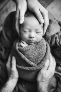 baby in parents hands- holly springs studio newborn pictures