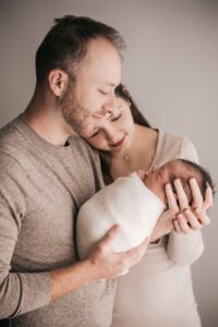 parents gazing at newborn baby, holly springs studio newborn pictures