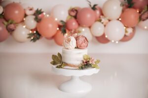 girl cake smash with peonies in Raleigh NC