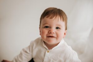 cary baby photographer Laura Karoline phography, baby dressed in white smiling