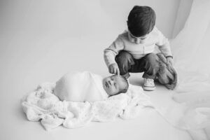 toddler exploring newborn baby newborn photos wake forest