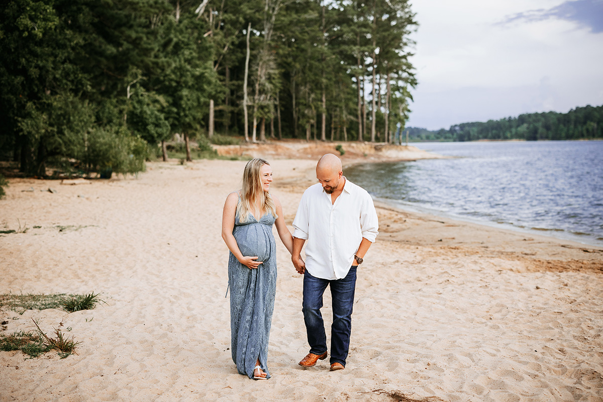 pregnant couple walking along beach, jordan lake maternity photos, laura karoline photography