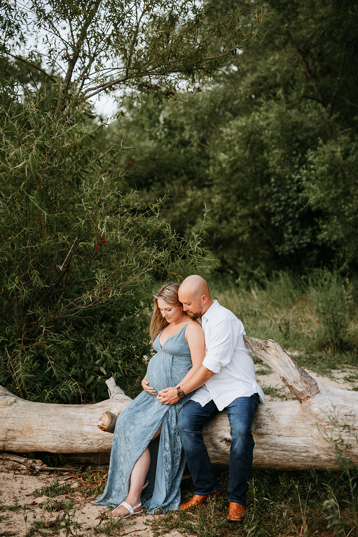 pregnant couple sitting on driftwood log, jordan lake maternity photos, laura karoline photography