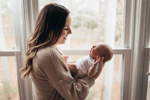 mom looking at baby yawning, Holly Springs Lifestyle Newborn Photos, Laura Karoline Photography