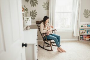 mom in rocking chair with newborn - Holly Springs Lifestyle Newborn Photos, Laura Karoline Photography