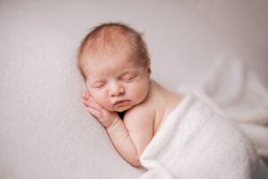 Raleigh newborn photographer, newborn baby on white blanket