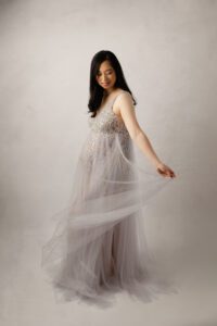 pregnant woman in wispy grey gown, studio maternity pictures Raleigh