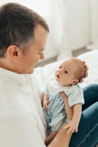 baby looking at dad, lifestyle newborn photographer holly springs