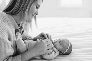 lifestyle newborn photos in apex, playing with newborn baby
