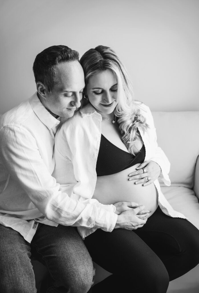 mom and dad looking at pregnant mom