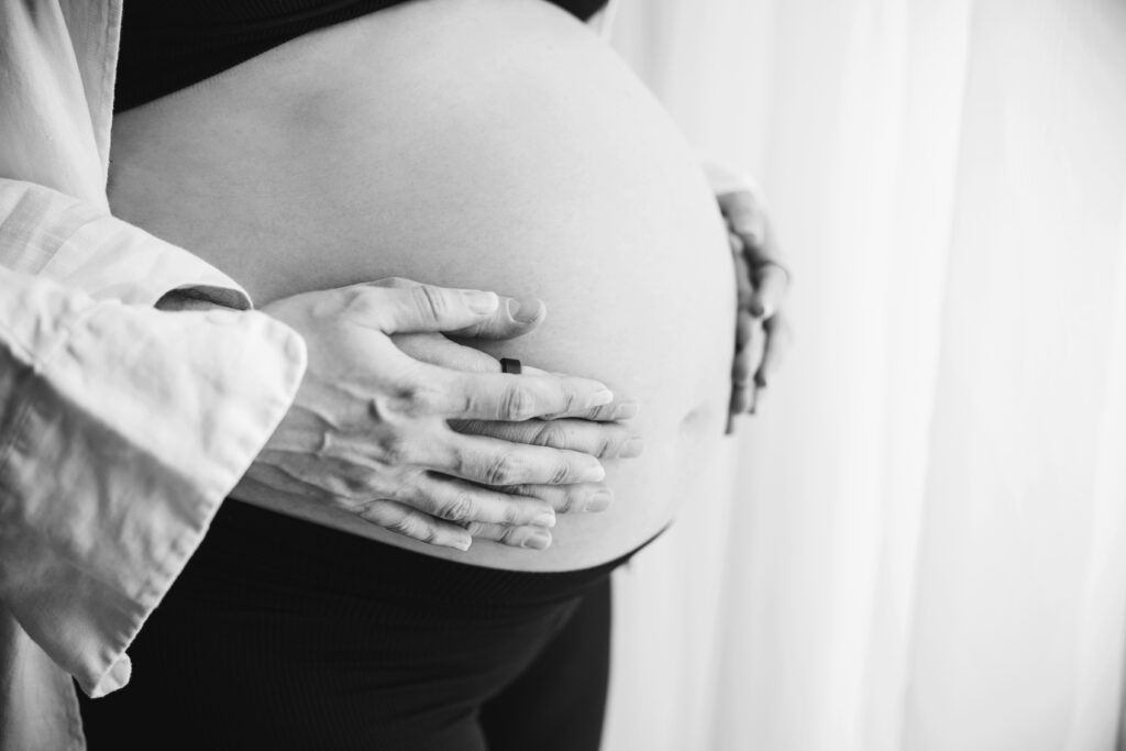 black and white photo of pregnant baby belly