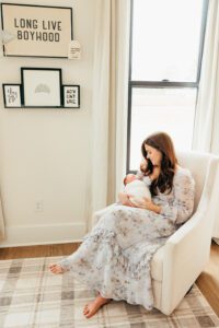 mom rocking with baby in nursery