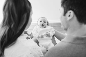 black and white photo of baby between mom and dad, cary in-home newborn pictures